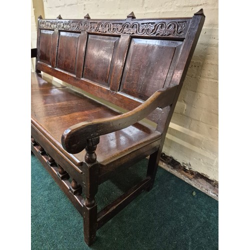 283 - AN ANTIQUE OAK VICTORIAN CARVED BENCH, IN THE JACOBEAN REVIVAL STYLE, HIGH PANELLED BACK WITH HEAVIL... 