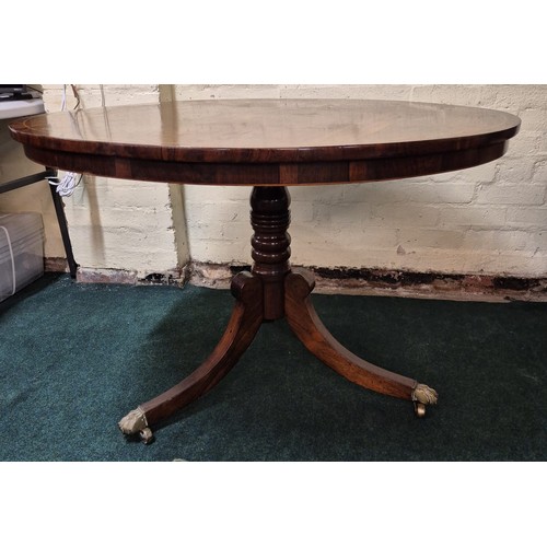 288 - A ROSEWOOD REGENCY ROUND BREAKFAST TABLE, TRIPOD OUT SWEPT LEGS WITH BRASS LIONS PAW FEET ON CASTORS... 