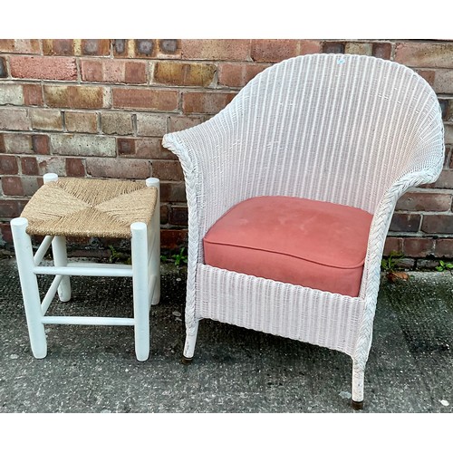 324 - A LLOYD LOOM WICKER ARMCHAIR IN WHITE WITH A WHITE PAINTED AND WICKER FOOT STOOL