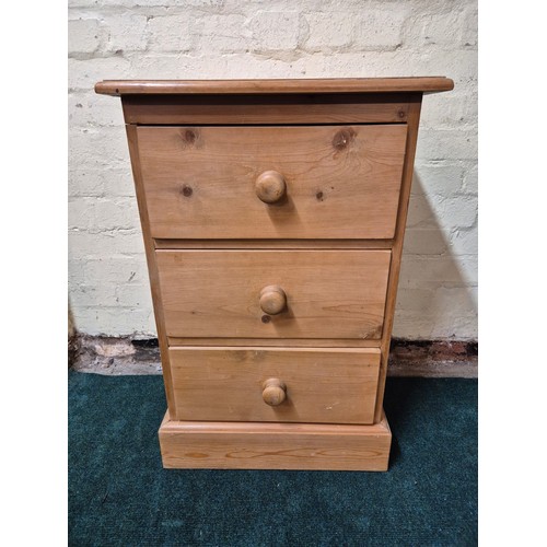 327 - A VINTAGE STRIPPED PINE THREE DRAWER BEDSIDE CHEST - APPROX 76.CM.H X 49.CM.W X 42.CM.D