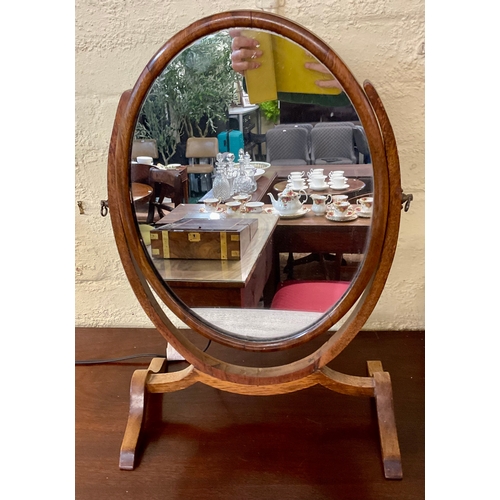 314A - A MAHOGANY OVAL SHAPED TILTING DRESSING TABLE MIRROR 54CM H X 36CM L