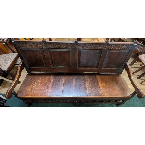 283 - AN ANTIQUE OAK VICTORIAN CARVED BENCH, IN THE JACOBEAN REVIVAL STYLE, HIGH PANELLED BACK WITH HEAVIL... 