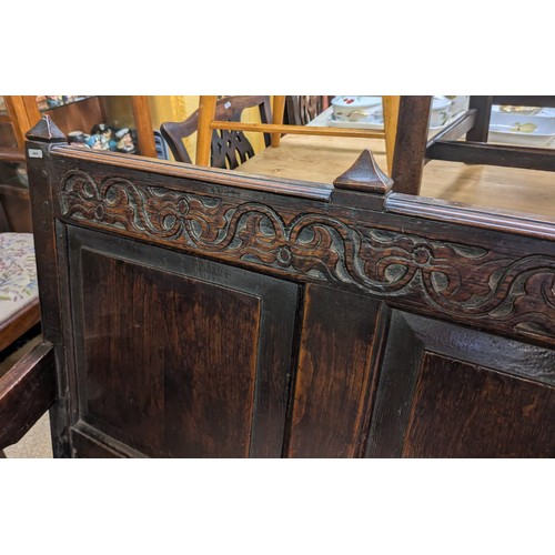 283 - AN ANTIQUE OAK VICTORIAN CARVED BENCH, IN THE JACOBEAN REVIVAL STYLE, HIGH PANELLED BACK WITH HEAVIL... 