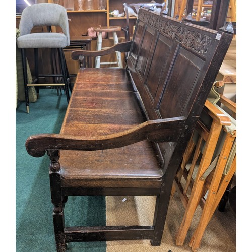 283 - AN ANTIQUE OAK VICTORIAN CARVED BENCH, IN THE JACOBEAN REVIVAL STYLE, HIGH PANELLED BACK WITH HEAVIL... 