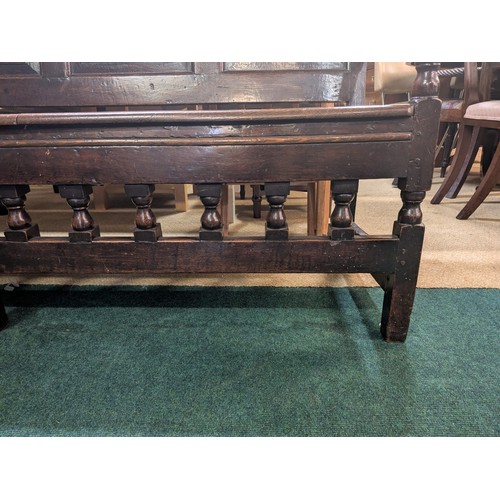 283 - AN ANTIQUE OAK VICTORIAN CARVED BENCH, IN THE JACOBEAN REVIVAL STYLE, HIGH PANELLED BACK WITH HEAVIL... 