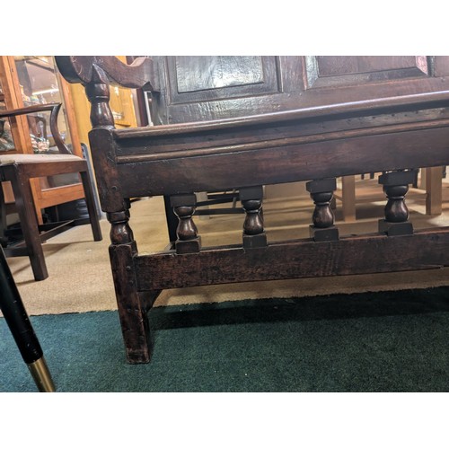 283 - AN ANTIQUE OAK VICTORIAN CARVED BENCH, IN THE JACOBEAN REVIVAL STYLE, HIGH PANELLED BACK WITH HEAVIL... 
