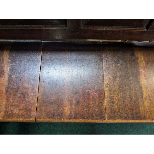 283 - AN ANTIQUE OAK VICTORIAN CARVED BENCH, IN THE JACOBEAN REVIVAL STYLE, HIGH PANELLED BACK WITH HEAVIL... 