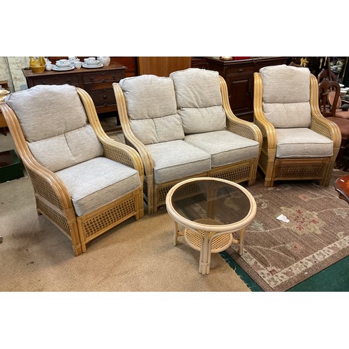 285 - A YELLOW CANE CONSERVATORY SUITE, CONSISTING OF TWO ARMCHAIRS AND A TWO SEATER SOFA, WITH UPHOLSTERE... 