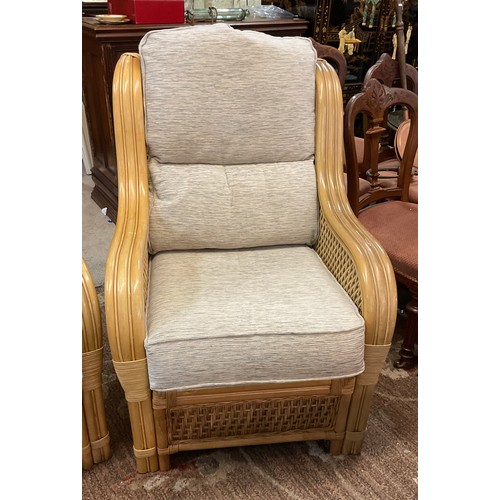 285 - A YELLOW CANE CONSERVATORY SUITE, CONSISTING OF TWO ARMCHAIRS AND A TWO SEATER SOFA, WITH UPHOLSTERE... 