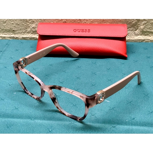 37 - PAIR OF GUESS SPECTACLE FRAMES WITH TORTOISE SHELL EFFECT TO FRAME AND PINK COLOUR TO ARMS. WITH CAS... 