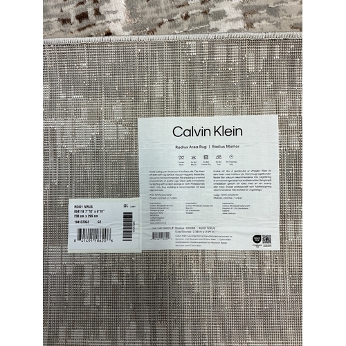 39 - CALVIN KLEIN ‘RADIUS’ SILVER/GREY/GOLD AREA RUG 238cm x 299cm