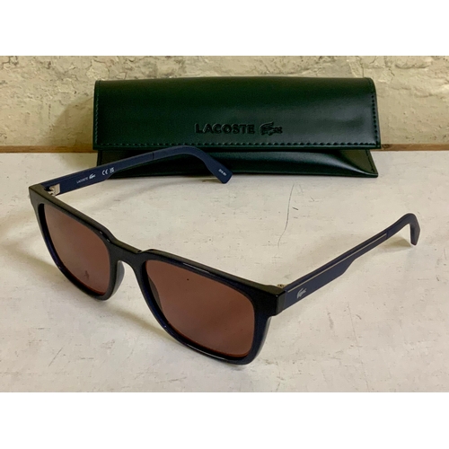 47 - PAIR OF LACOSTE SUNGLASSES IN BLACK AND BLUE MADE FROM PLANT BASED RESIN - L6077S