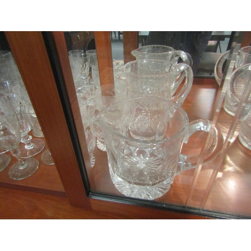 1009 - A collection of glasswares including cut glass examples, jugs, wine glasses, etc