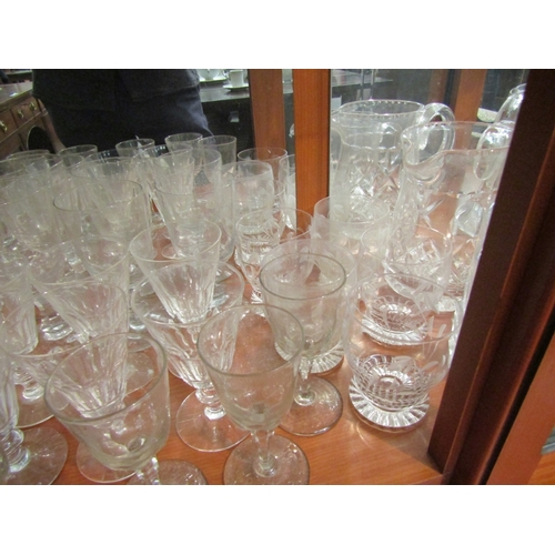 1009 - A collection of glasswares including cut glass examples, jugs, wine glasses, etc