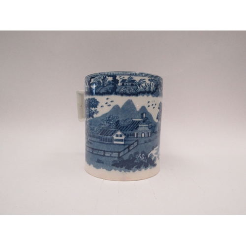 1442 - A large mug/tankard with blue and white transferware decoration, paper label to base 