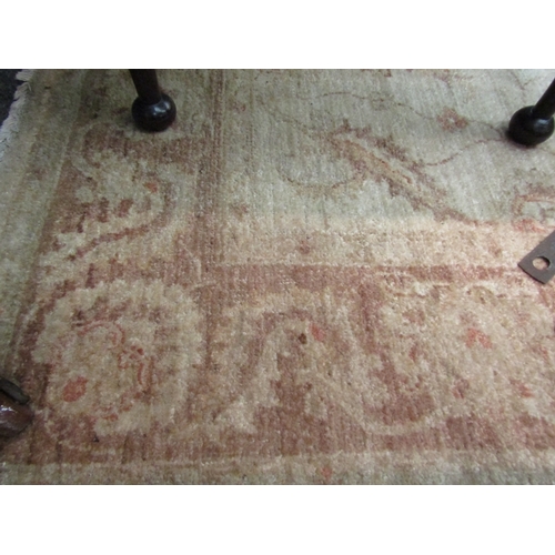 1652 - A wool cream carpet, beige foliate border and central pattern, 215cm x 155cm