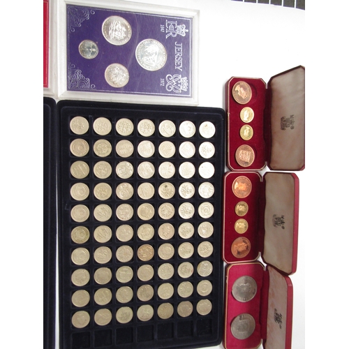 1440 - A box of assorted coins to include cased Jersey pre-decimal coin sets, silver proof £1 and two trays... 