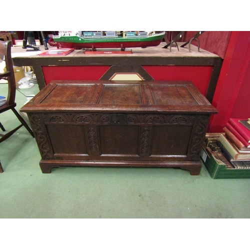 16 - A 17th Century and later oak three panel coffer the split hinged rising top over a carved front on b... 