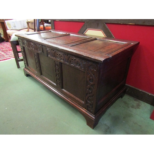 16 - A 17th Century and later oak three panel coffer the split hinged rising top over a carved front on b... 