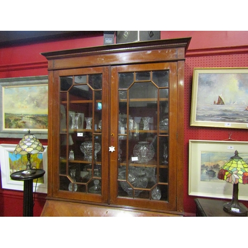 45 - A 1930's mahogany bureau bookcase, the dentil inlaid top over astragal glazing to a fall front, twin... 