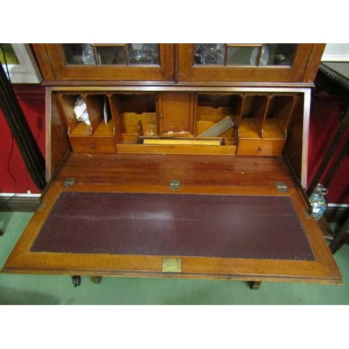 45 - A 1930's mahogany bureau bookcase, the dentil inlaid top over astragal glazing to a fall front, twin... 