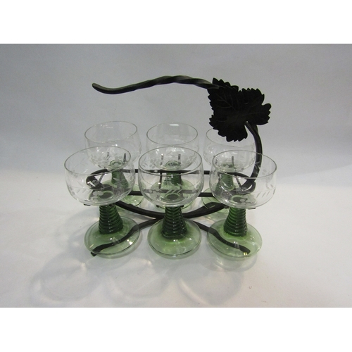 66 - A set of six green stem wine goblets with grape and vine etched design together with a metal carryin... 