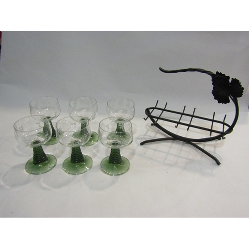 66 - A set of six green stem wine goblets with grape and vine etched design together with a metal carryin... 