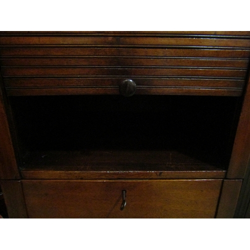 145 - A 19th Century mahogany nightstand the tambour front top over a single base drawer on castors with w... 