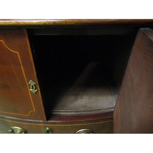 123 - A George III flame mahogany bow front nightstand with satinwood line inlay, the two door cupboard ov... 