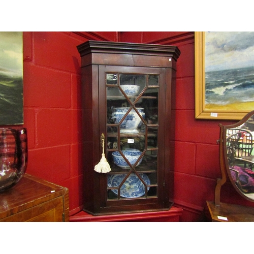 148 - A George III mahogany wall hanging astragal glazed single door corner cabinet with working lock and ... 