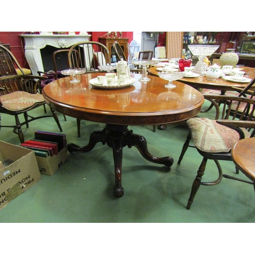 178 - A Circa 1860 burr walnut quarter veneer oval tilt top table on a turned and carved base with scroll ... 