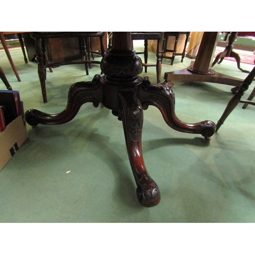 178 - A Circa 1860 burr walnut quarter veneer oval tilt top table on a turned and carved base with scroll ... 