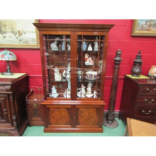 137 - A Georgian revival flame mahogany cabinet on base the two glazed doors over a two door cupboard with... 