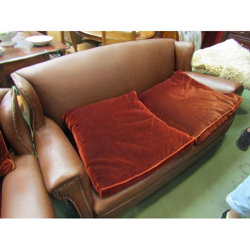 170 - A brown leatherette sofa with two armchairs