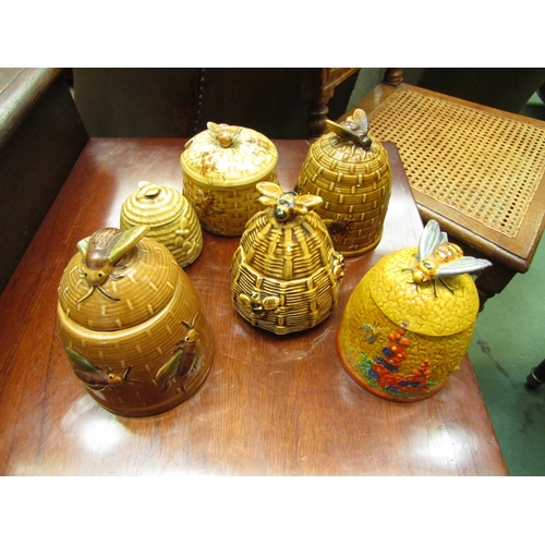 189 - Six various bee design lidded honey pots, some a/f