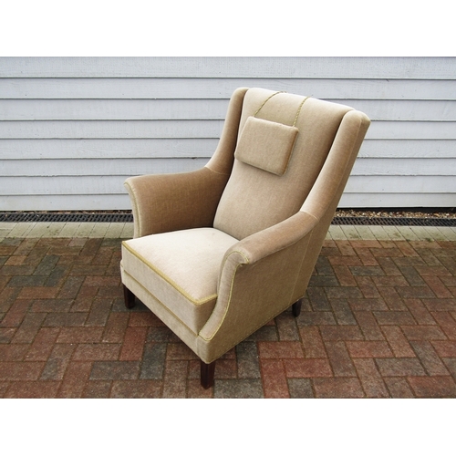 191 - A 1940's Danish armchair with high back, stained hardwood legs, original beige velor upholstery and ... 