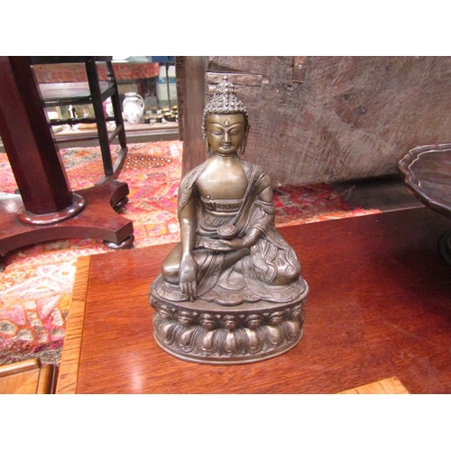 209 - An early 20th century bronze seated Buddha 30.5cm high