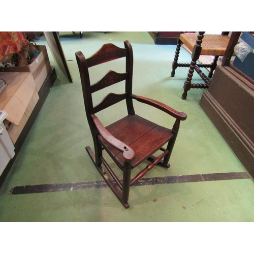 228 - Circa 1800 an oak child's rocking chair the three rung ladder back rest with handpainted floral deco... 