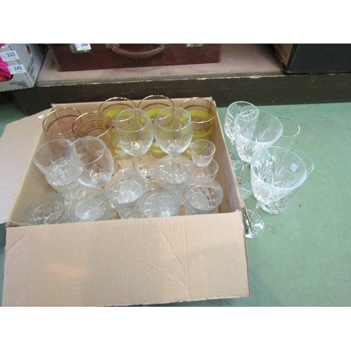 246 - A box of mixed drinking glasses including cut glass tumblers and wine glasses etc.