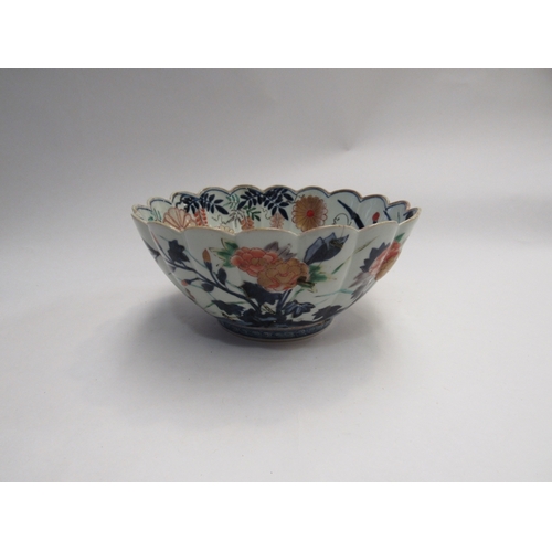 426 - A Japanese fluted bowl decorated with marigolds inside and out. 24cm diameter. A/f, stapled repairs ... 