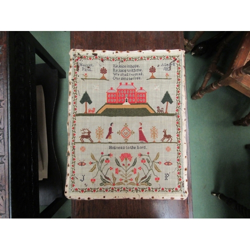 183 - An early 19th Century sampler worked by Harriet Paul backed onto linen with religious text and figur... 