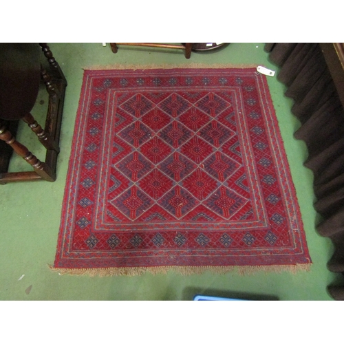 3 - A square rug with diamond geometric patterned centre on red ground with tasselled ends, 125 x 125cm