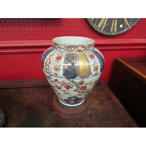 31 - An Imari vase on wooden Chinese stand, 22cm tall