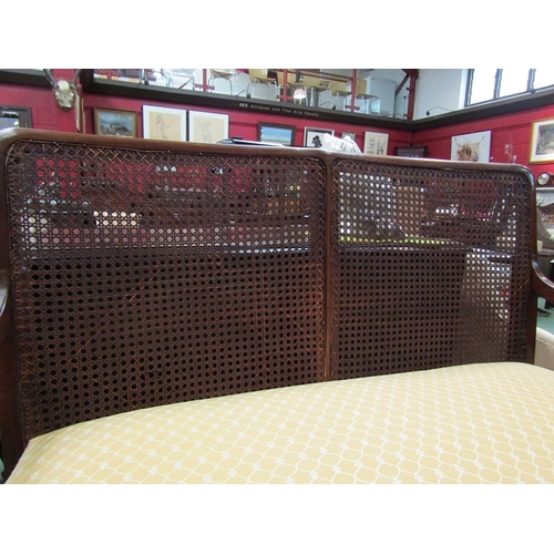 114 - An Edwardian bergere mahogany two seater sofa on square tapering legs      (R) £140