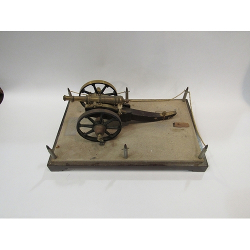 311 - A cannon mounted onto a base supported by bullet shell corners     (R) £40