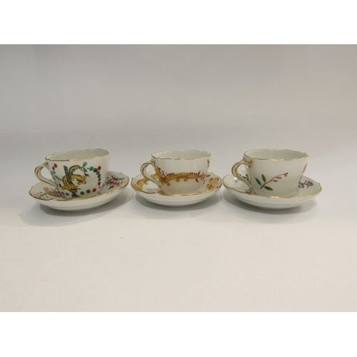 318 - Three Meissen cups and saucers decorated in Chinoiserie patterns, dragons, butterflies, etc twist ha... 