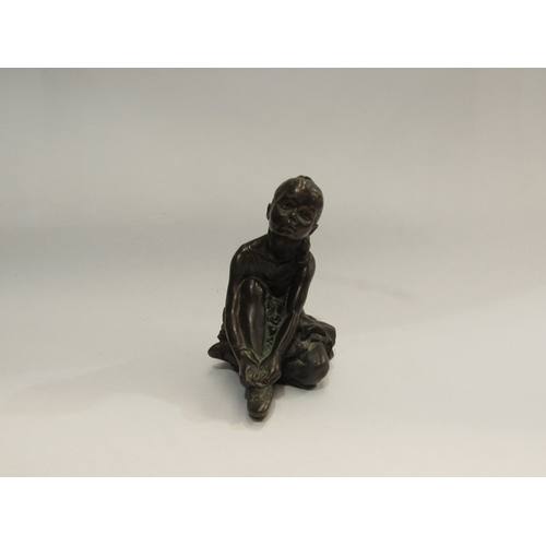 320 - A bronzed figure of a seated ballet dancer, 11.5cm tall