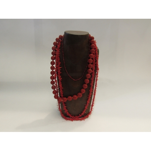 322 - A necklace of cinnabar type beads, faux coral necklace and red glass bugle bead necklace (3)    (R) ... 