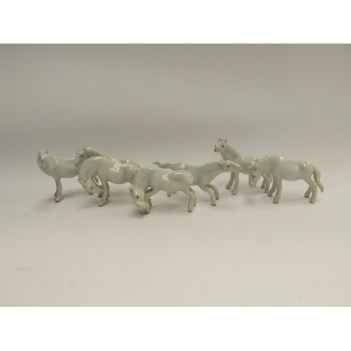 340 - A set of seven miniature white ceramic horses