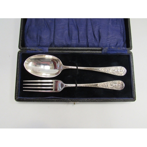 348 - A cased silver fork and spoon with figural scenes